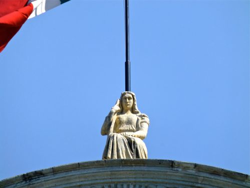 Seated female statue on top of Cathedral